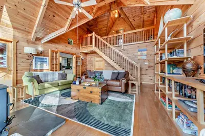 a log home living room with a spiral staircase at 3 Bed in Kippford oc-g30100 in Kippford