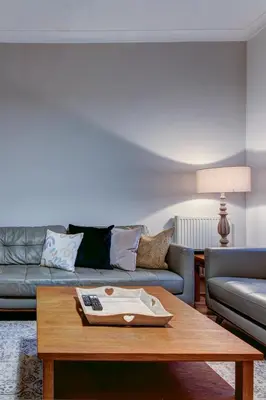 a living room with a couch and a coffee table at The Fullarton - Coorie Doon Stays in Troon