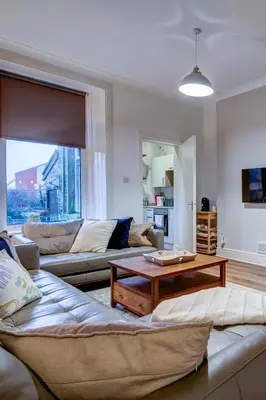 a living room with a couch and a coffee table at The Fullarton - Coorie Doon Stays in Troon
