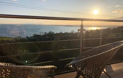 a hammock on a balcony with a view of the grand canyon at Little Beach in Gatehouse of Fleet