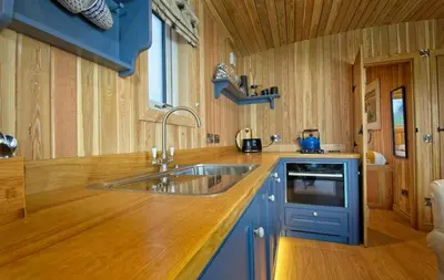 a kitchen with a sink and a wooden counter top at Little Oak in Gatehouse of Fleet