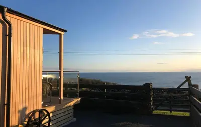 a view of the ocean from the balcony of a house at Little Oak in Gatehouse of Fleet