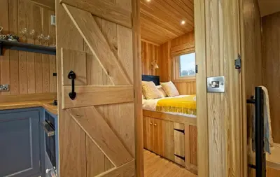 a sliding barn door in a tiny house at Little Oak in Gatehouse of Fleet