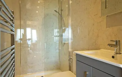 a bathroom with a glass shower and a sink at Little Willow in Gatehouse of Fleet