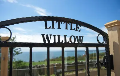 a metal gate with the words little window on it at Little Willow in Gatehouse of Fleet