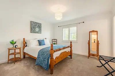 a bedroom with a bed and a mirror in it at 3 Bed in Longtown oc-h30069 in Longtown