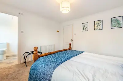 a bedroom with a bed with a blue blanket on it at 3 Bed in Longtown oc-h30069 in Longtown
