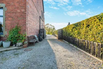 a brick building with a fence next to a street at 3 Bed in Longtown oc-h30069 in Longtown