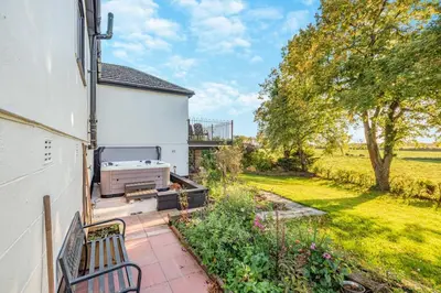 a patio with a white building and a grill at 3 Bed in Longtown oc-h30069 in Longtown