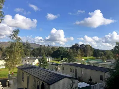 a view of a small town with houses and trees at Cosy 3BR Getaway in Beautiful Country Park - Pass the Keys in Beattock