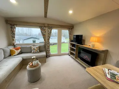 a living room with a couch and a fireplace at Cosy 3BR Getaway in Beautiful Country Park - Pass the Keys in Beattock