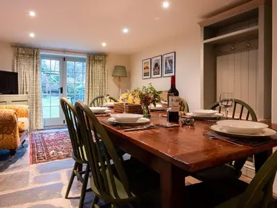 a dining room with a wooden table and chairs at Stone Arthur Cottage in Ambleside