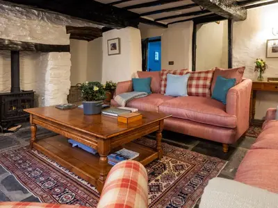 a living room with a couch and a coffee table at Stone Arthur Cottage in Ambleside