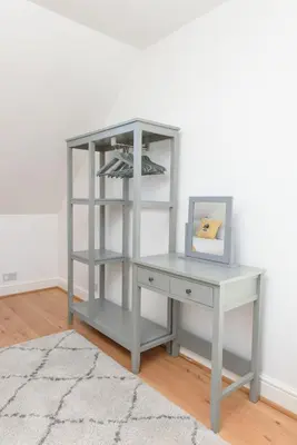 a gray desk with a white shelf and a picture at Mulberry Cottage in Whithorn