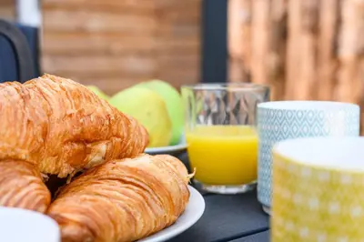 a table with a plate of croissants and a glass of orange juice at Ivy in Whithorn