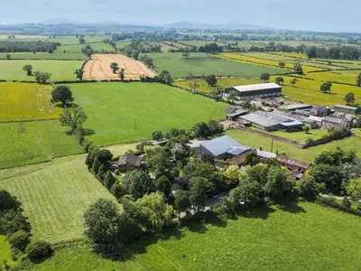 an aerial view of a house in a field at Larch Lodge in Penrith