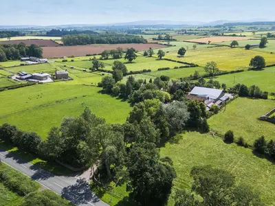 an aerial view of a field with trees and houses at Larch Lodge in Penrith