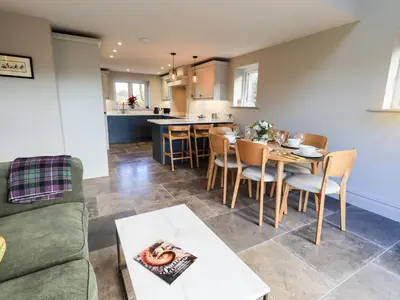 a living room with a couch and a table at The Elterwater Barn in Workington