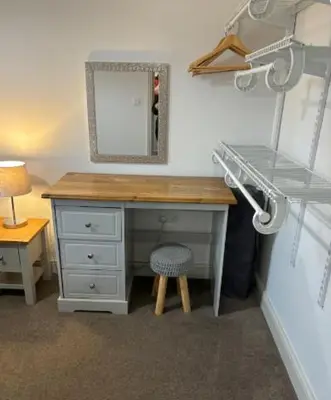 a desk in a room with a mirror and a lamp at Unique, Large 2 bedroom Flat in Carlisle