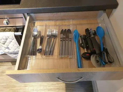 a drawer filled with utensils in a cabinet at Ground Floor Studio in Longtown