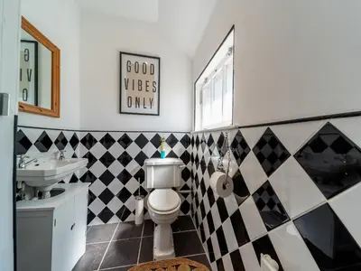 a bathroom with a toilet and a sink at Mossknowe Escape in Annan