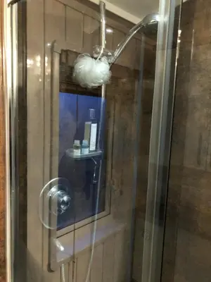 a shower in a bathroom with a glass door at Woodland Lodge in Plumbland