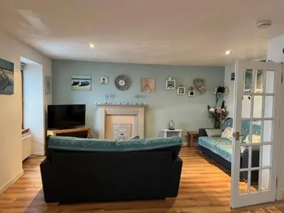 a living room with a couch and a television at Harbour View Irvine in Irvine