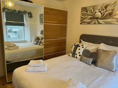 a bedroom with two beds and a large mirror at Harbour View Irvine in Irvine