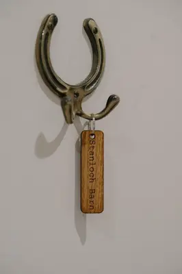 a key with a tag on it on a wall at Cosy wee cottage -modern, open plan, parking, EV in Glencaple