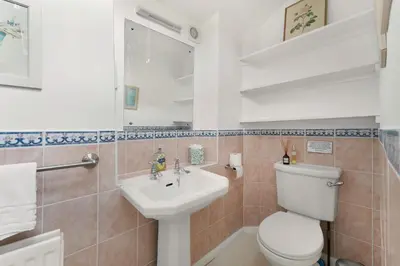 a bathroom with a toilet and a sink at Rowan Studio Cottage in Grasmere
