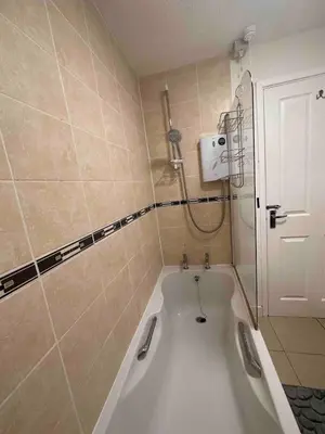 a bath tub in a bathroom with a shower at A Cozy One Bedroom Flat for Two Guests in Carlisle