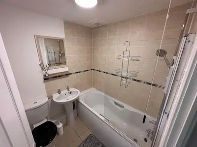 a bathroom with a sink and a tub and a toilet at A Cozy One Bedroom Flat for Two Guests in Carlisle