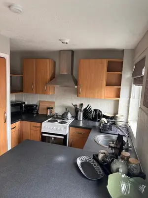 a kitchen with a sink and a stove top oven at A Cozy One Bedroom Flat for Two Guests in Carlisle