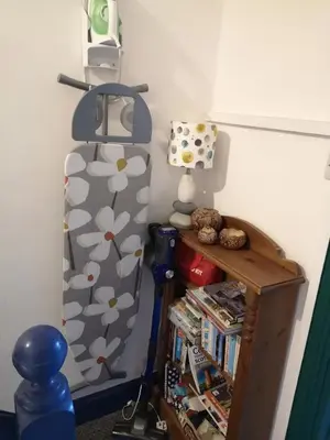 a room with a bed and a shelf with books at Carlisle Homestay - Family Room in Carlisle