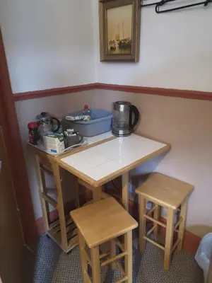 a small table and two stools in a room at Carlisle Homestay - Family Room in Carlisle