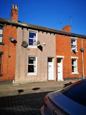 a red brick building with white doors and windows at Carlisle Homestay - Family Room in Carlisle