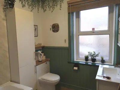 a bathroom with a toilet and a sink and a window at Carlisle Homestay - Double Room in Carlisle