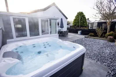 a hot tub in the backyard of a house at Hidden Hive in Gretna