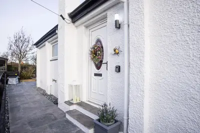 a wreath on the door of a white house at Hidden Hive in Gretna