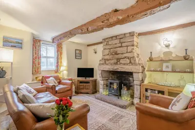 a living room with couches and a stone fireplace at 2 Bed in Greystoke oc-s30412 in Greystoke