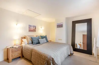 a bedroom with a large bed and a mirror at 2 Bed in Greystoke oc-s30412 in Greystoke