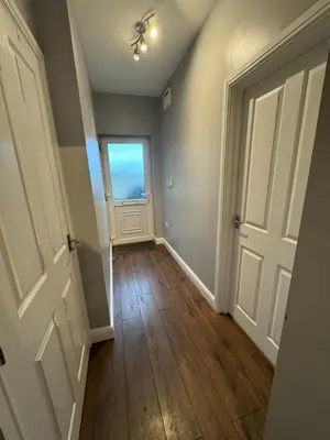an empty hallway with a door and a window at Omega Apartment - 3 Bedrooms - Sleeps 5 in Whitehaven