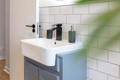 a bathroom with a white sink and a mirror at The Annick Suite No1 - Donnini Apartments in Irvine