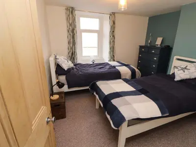 a bedroom with two beds and a window at Seahaven in Maryport
