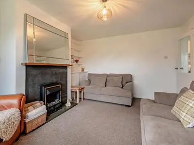 a living room with a couch and a fireplace at 3 Bed in Keswick 95858 in Keswick