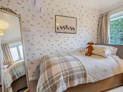a teddy bear sitting on a bed in a bedroom at 3 Bed in Keswick 95858 in Keswick