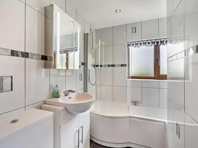 a white bathroom with a sink and a bath tub at 3 Bed in Wigton oc-95374 in Uldale