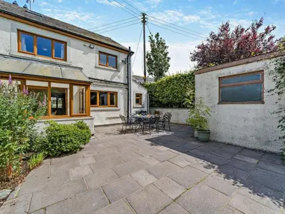 a patio with a table and chairs in front of a house at 3 Bed in Wigton oc-95374 in Uldale