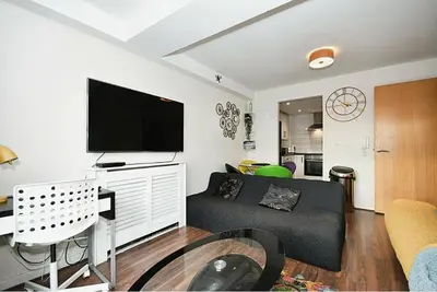 a living room with a couch and a flat screen tv at The Igloo Viewoint City Centre Stay & Free Parking in Moffat