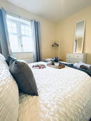 a bedroom with a large white bed with a window at Linga House - 3 Bedrooms - Sleeps 5 in Frizington